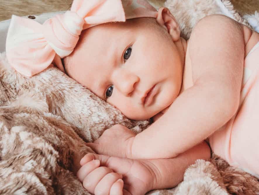 baby girl on pink blanket - testimonial for The Edwards Family
